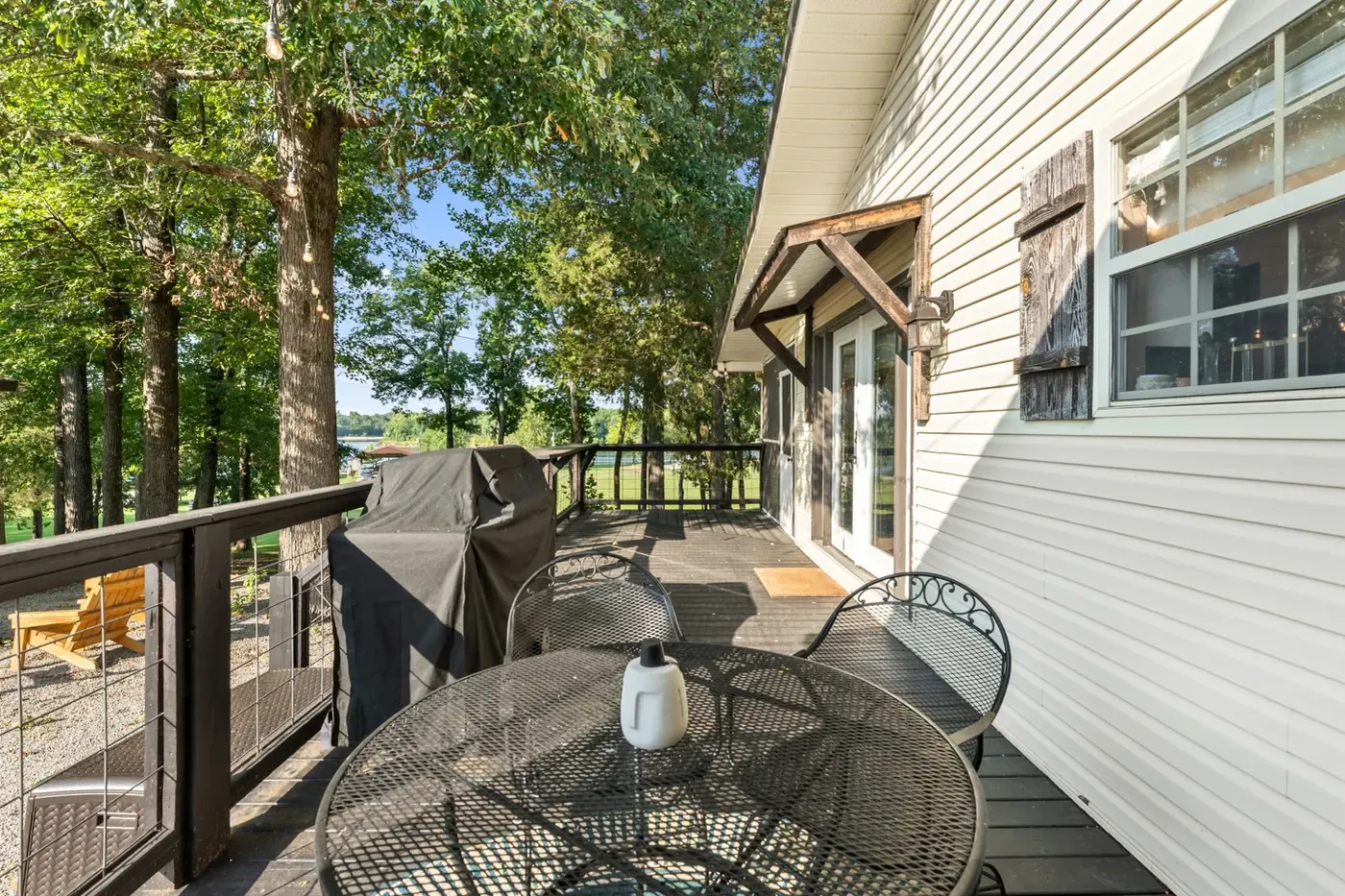 Open deck with cable railing running along the back of the house