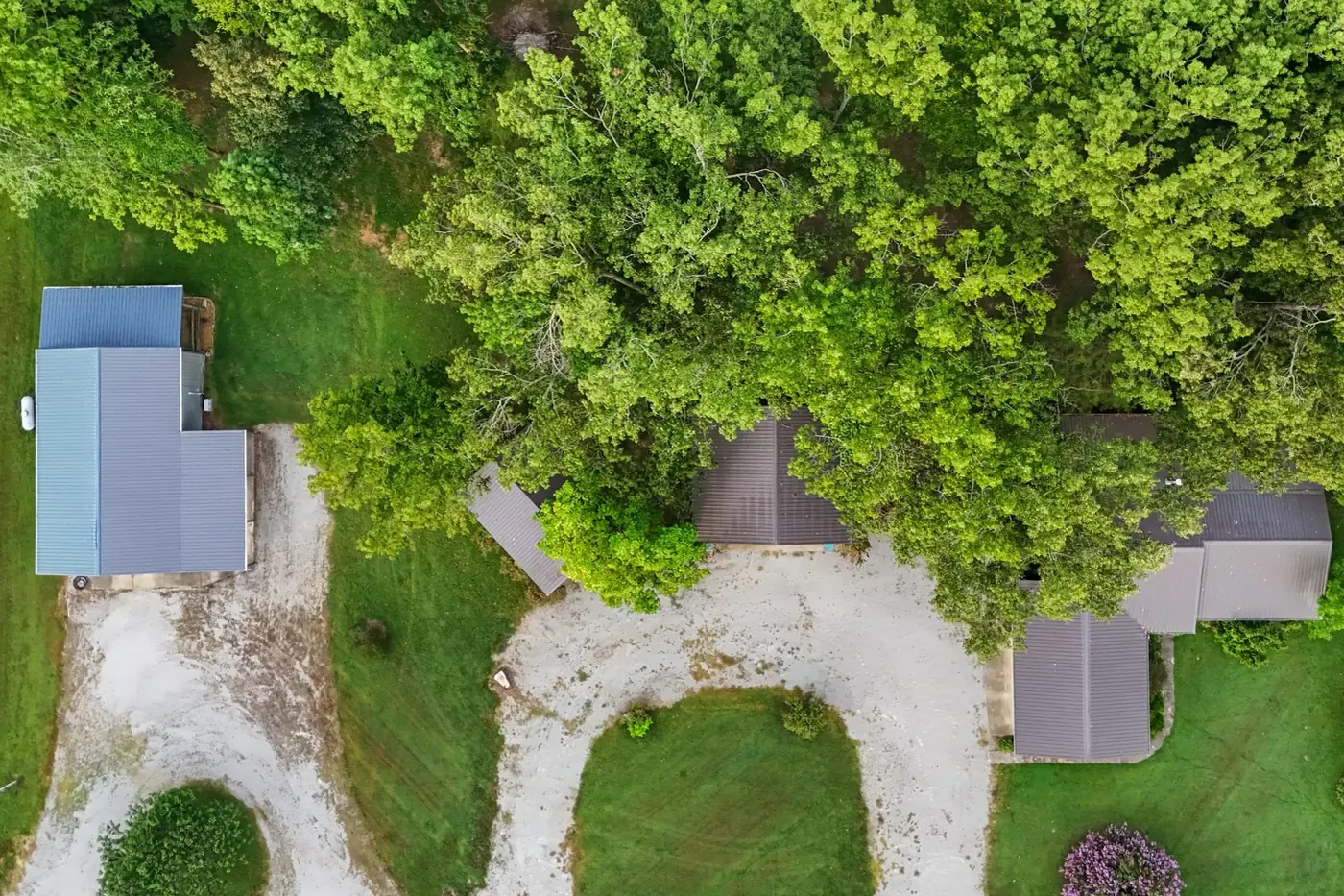 Looking down on the house, the shop and the gravel drive