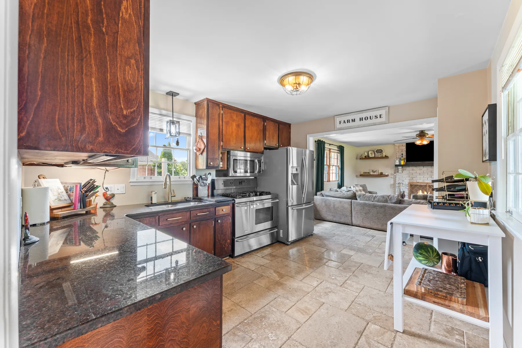 Kitchen with granite counters and stainless appliances, open to the living space