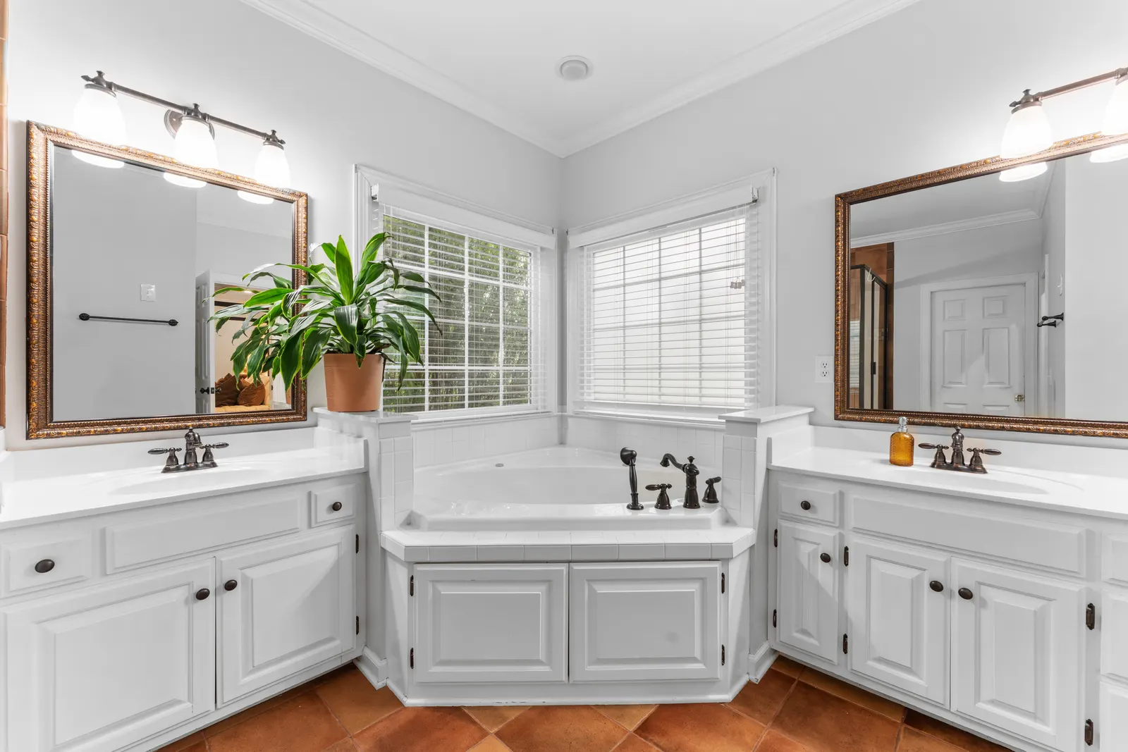 Primary bath with dual vanities and a corner soaking tub