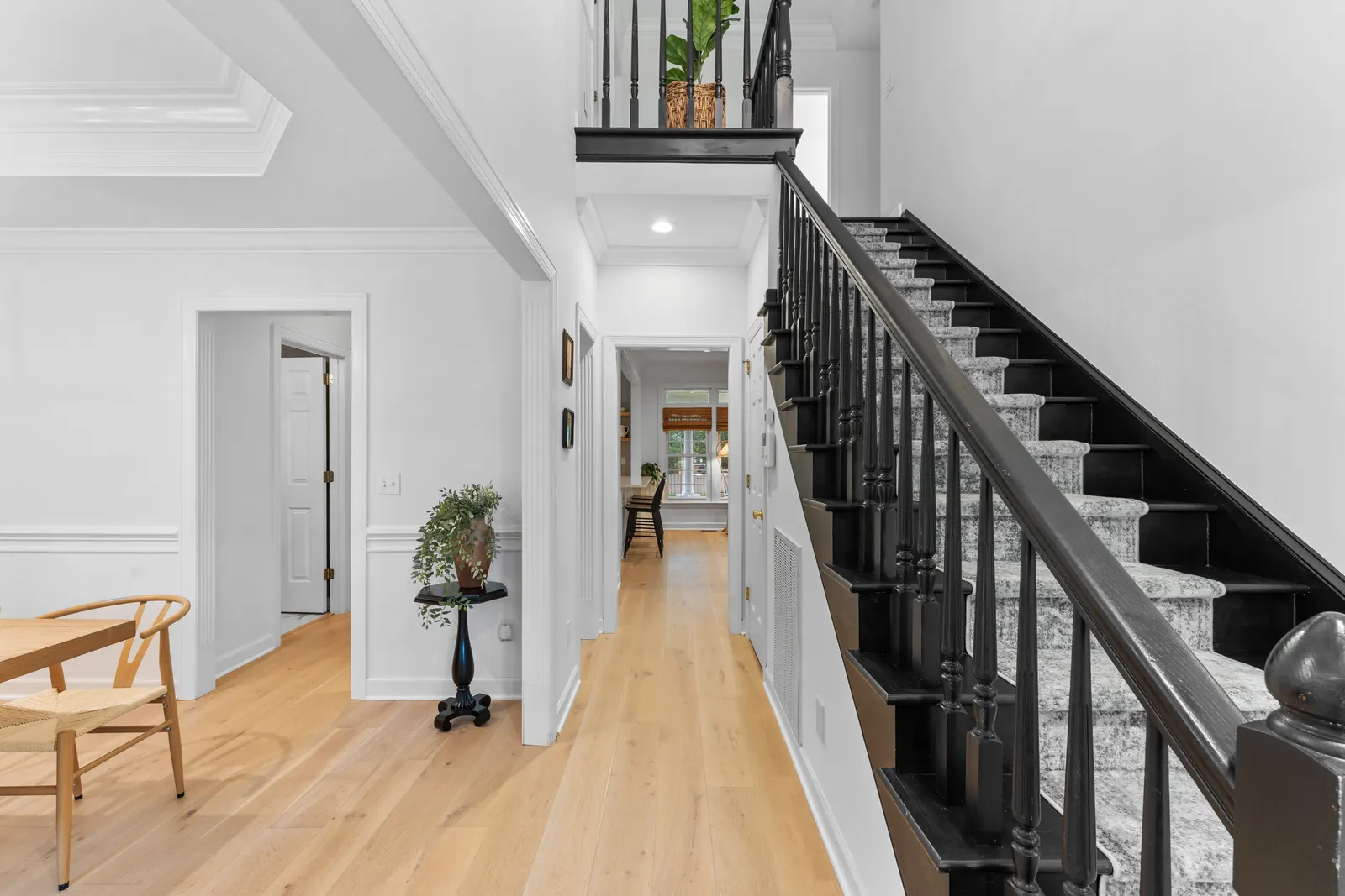 Entry foyer with hardwood floors and a staircase