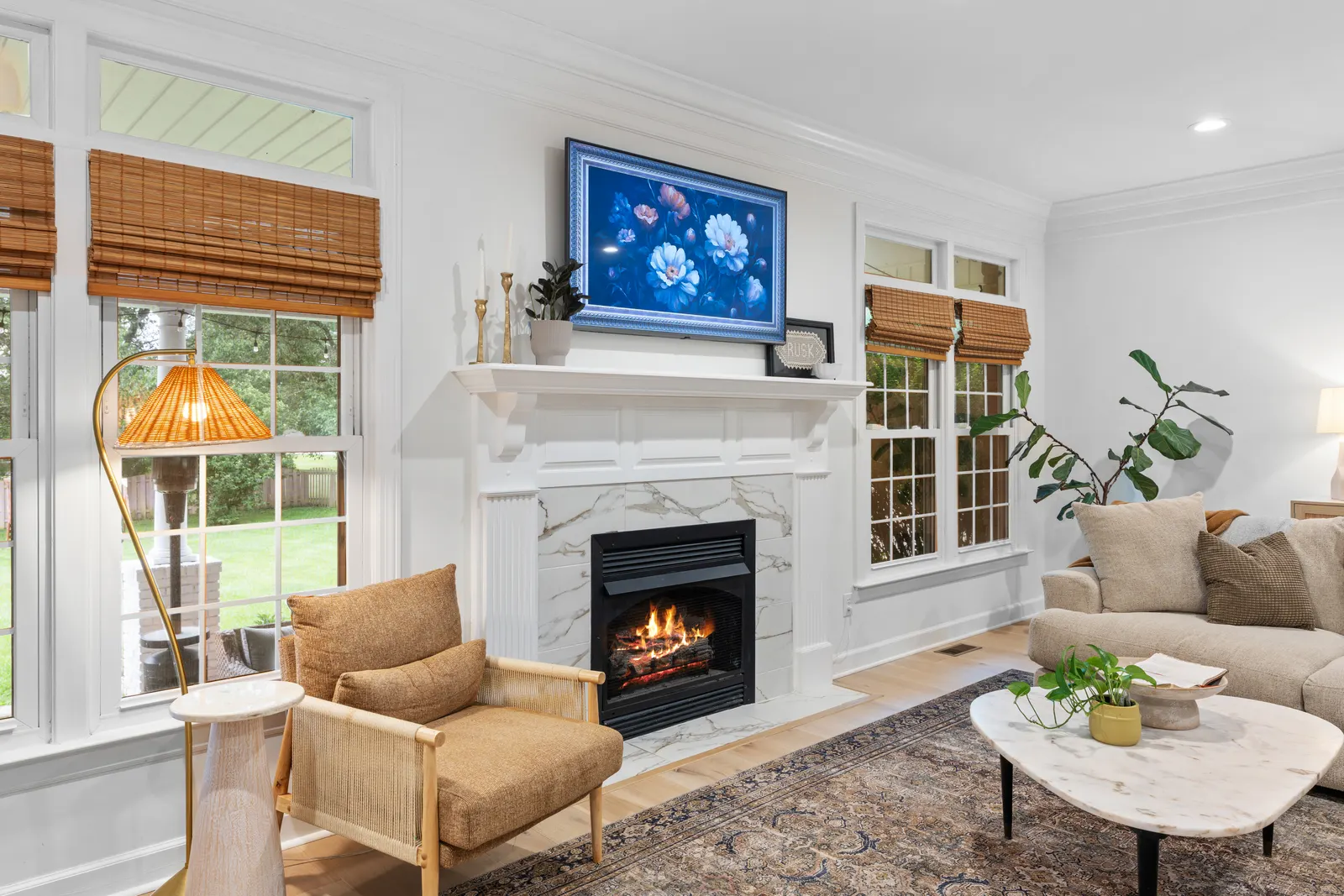 Great room with a marble fireplace and built-in windows