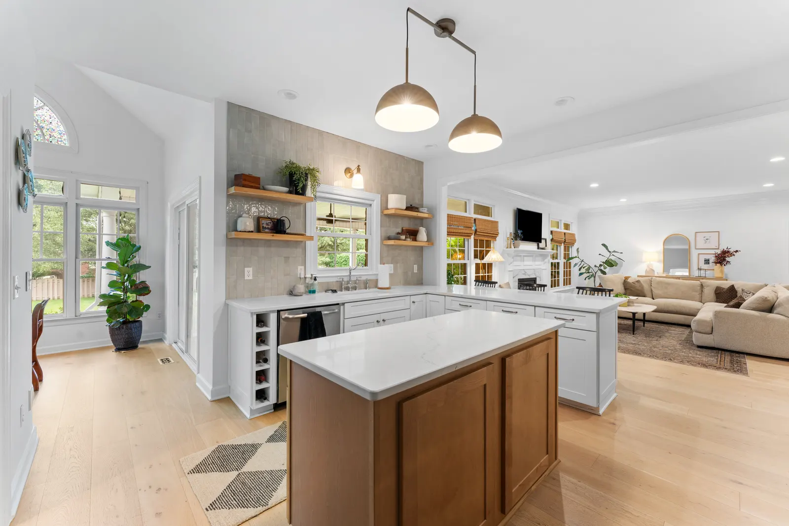 Gourmet kitchen with a wood island and pendant lighting