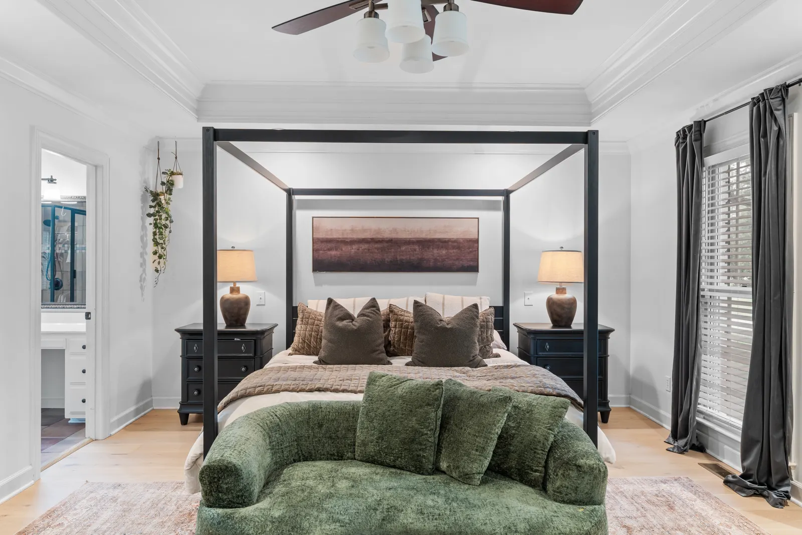 Primary suite with a canopy bed and tray ceiling