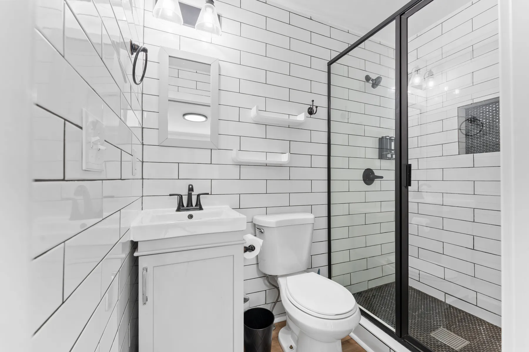 Renovated bathroom with subway tile and a glass shower