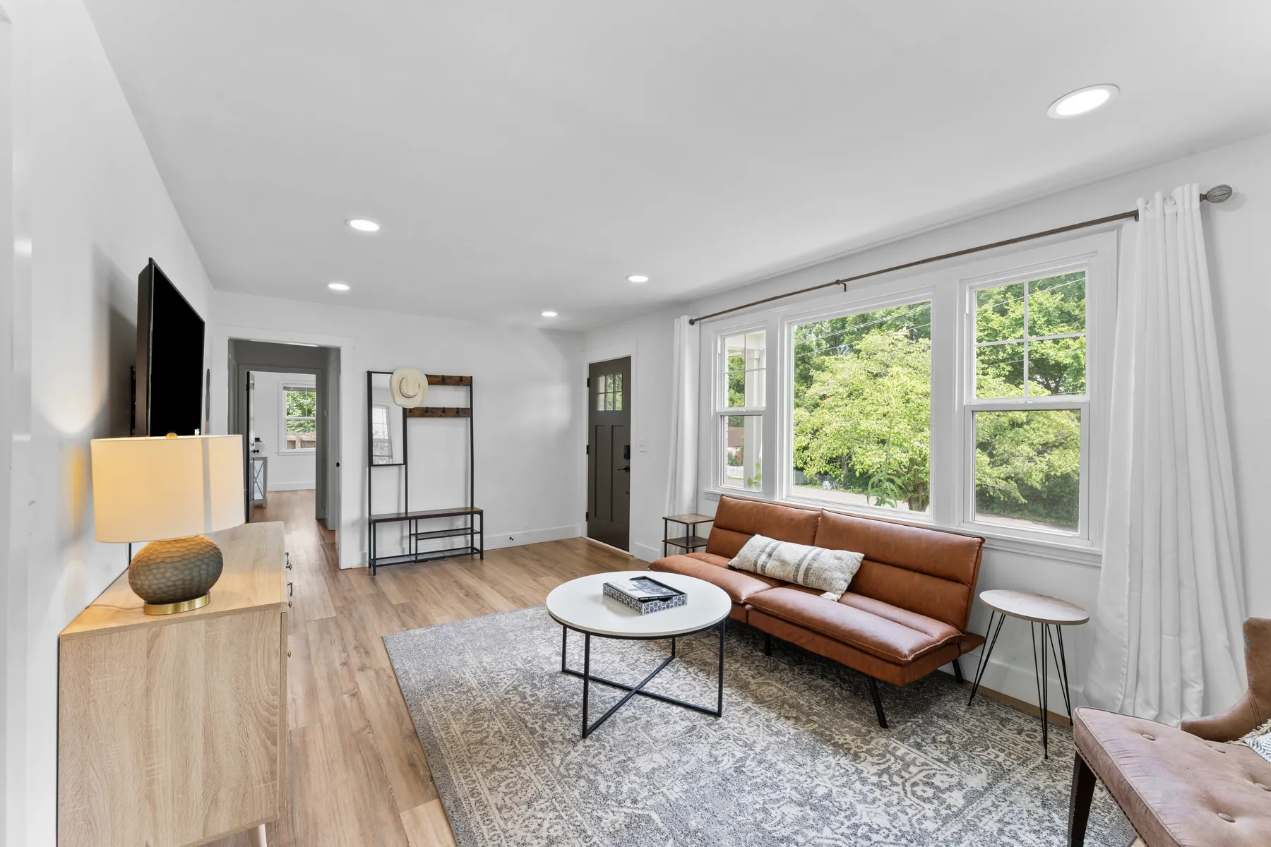 Bright staged living room with wood floors