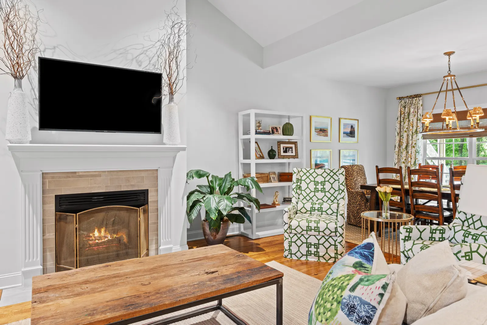 Great room with a fireplace and built-ins, open to the dining area