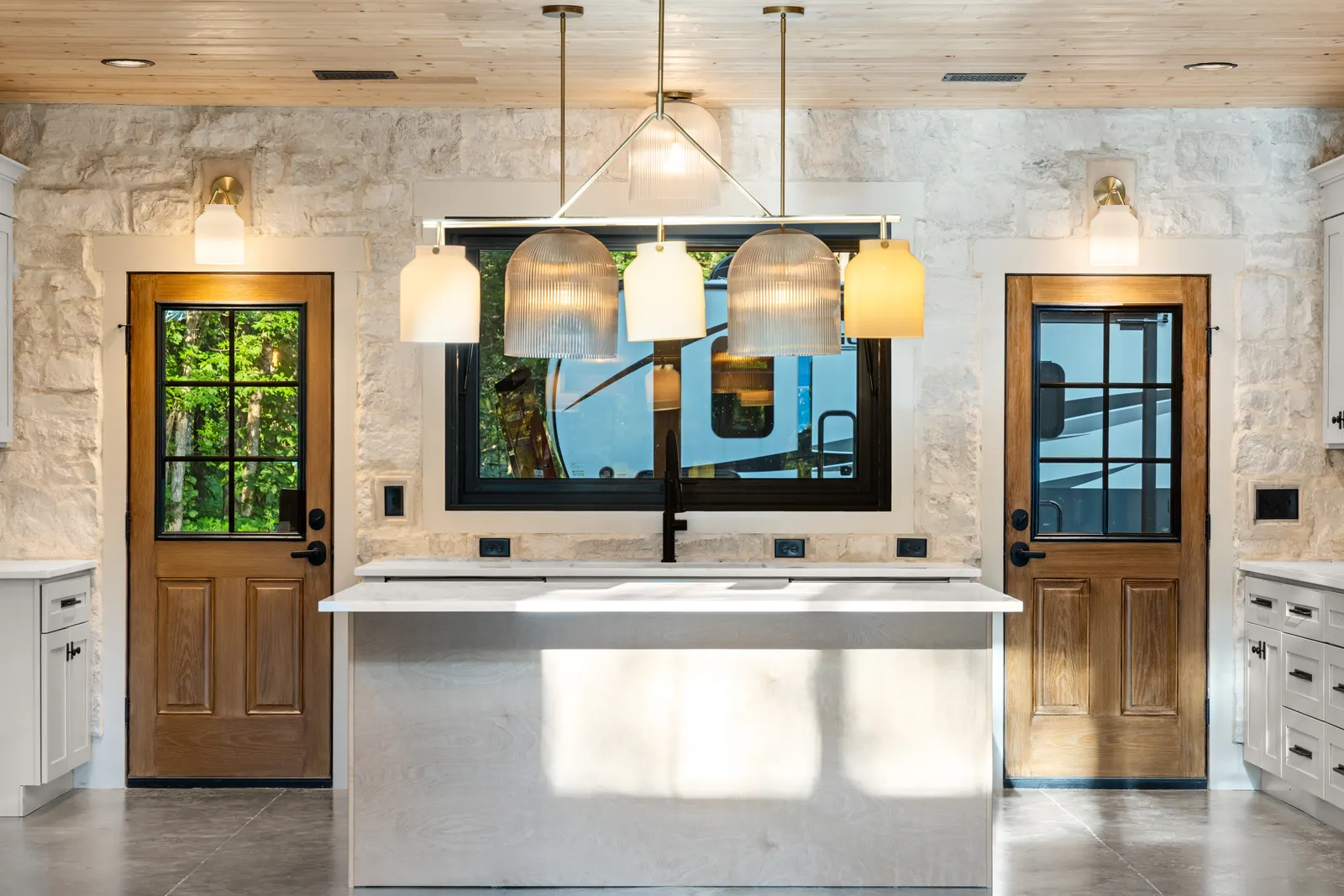 Kitchen with stone accent wall and pendant lighting