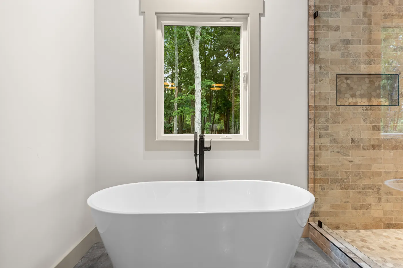Freestanding soaking tub by a window